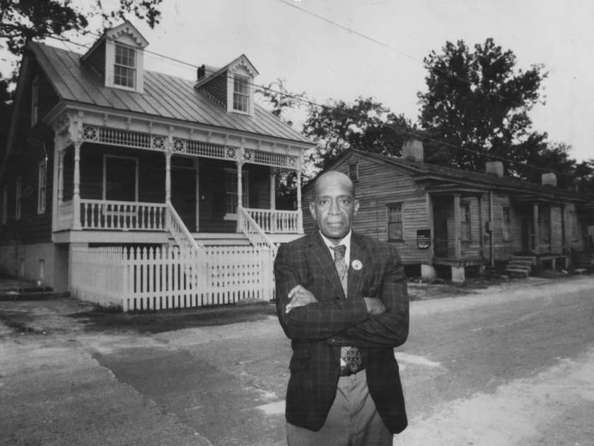 W. W. Law standing by house