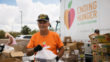 Veteran helps with food distribution at All Faiths Food Bank Photo by GCCF resize